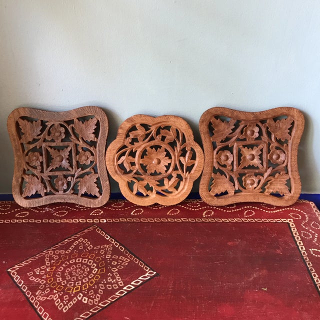This gorgeous collection of handmade trivets are intricately carved in a floral pattern and are perfect for your dining...
