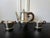 An early set of sterling silver coffee or tea set comprising a coffee or tea pot, a cream jug and an open sugar bowl....