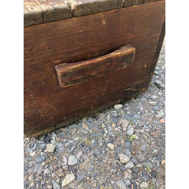 Charming distressed small wooden trunk having wooden handles and wonderful patina.