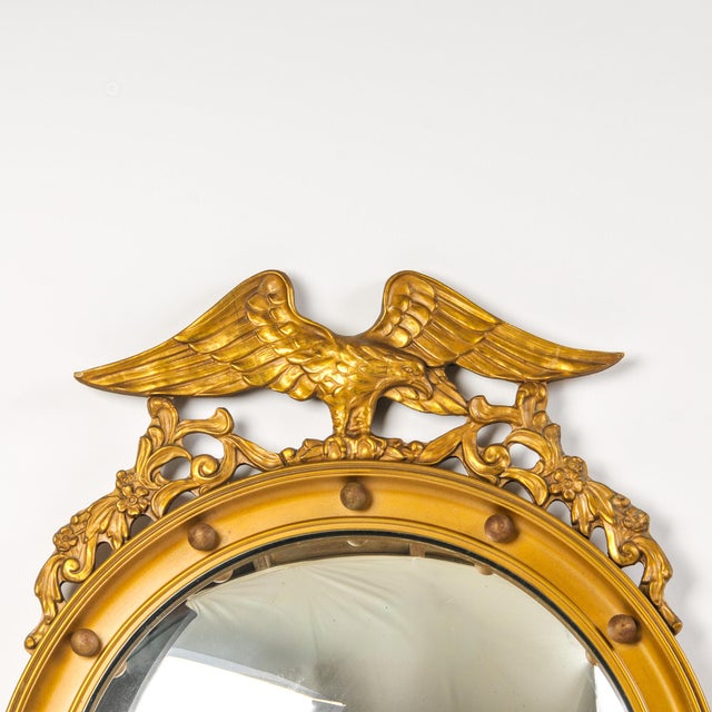 Fantastic large gilded wood convex glass eagle mirror. This bullseye mirror features the perched American eagle and...