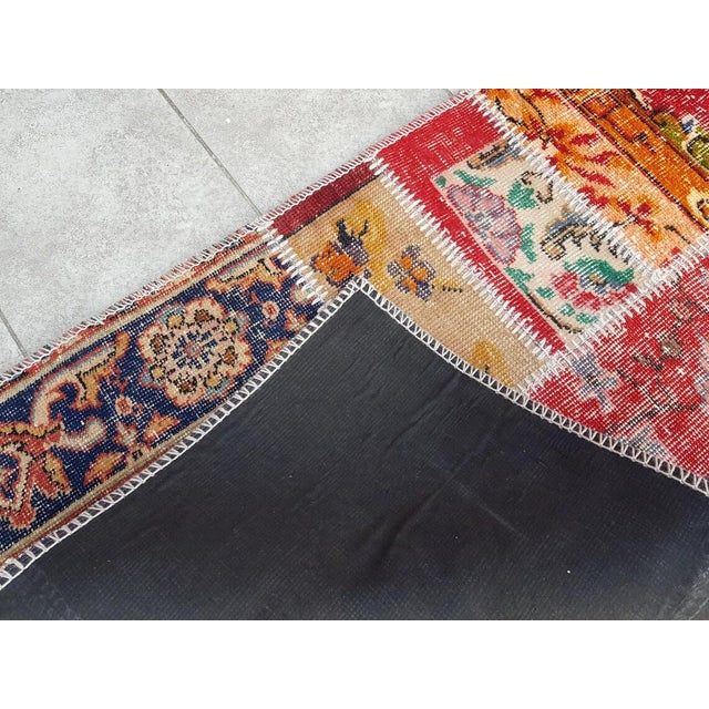 This is a vintage Turkish Oushak rug from the Mid 20th Century. The piece was hand-knotted.