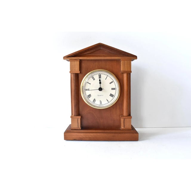 A vintage, mid-century handmade wooden clock in a neoclassical architectural building shape with a pointed pediment and...