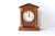 A vintage, mid-century handmade wooden clock in a neoclassical architectural building shape with a pointed pediment and...