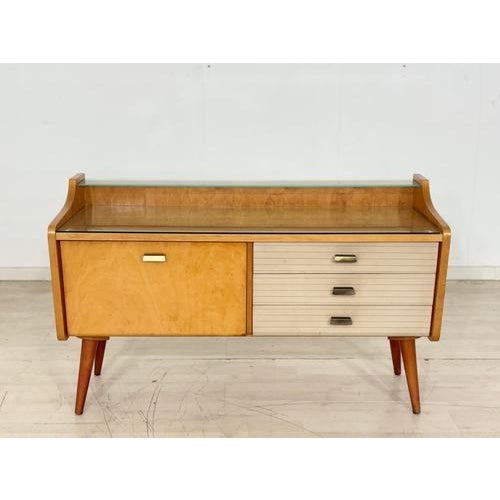 For sale is a stylish mid-century lowboard from the 1960s. This piece of furniture impresses with its clean lines, elegant...