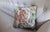 Beautiful Needlepoint Pillow featuring a charming bunny rabbit design amidst a vibrant tulip garden. The front showcases...