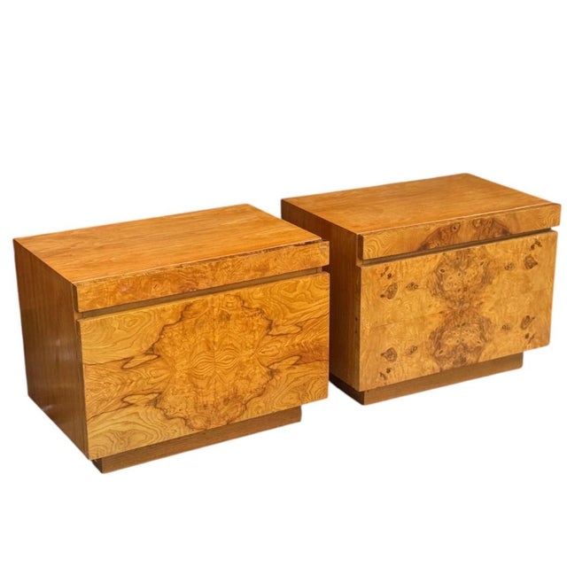 Pair of Lane nightstands, circa 1970s. Burl wood veneer drawer fronts with bookmatched pattern. Warm honey tone with...