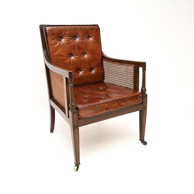 A beautiful and extremely well made antique Edwardian leather and caned armchair. This was made in England, it dates from...