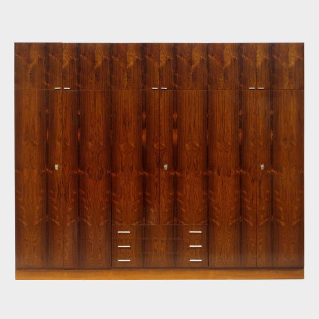 Large vintage mid century modern XL wardrobe in rosewood from the 1960s. This exclusive wardrobe features 12 cabinet...