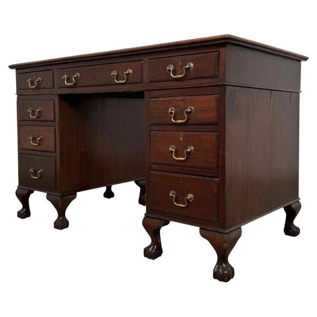 A handsome English Edwardian pedestal desk dating from the early 20th century, finely constructed in mahogany and...