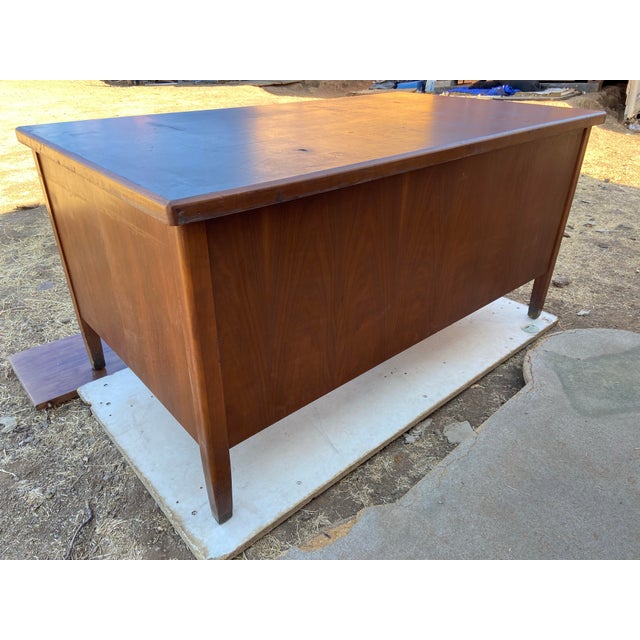 The Vintage Leopold Desk is a stunning piece of mid-century modern furniture made of wood and has a drawer for files With...