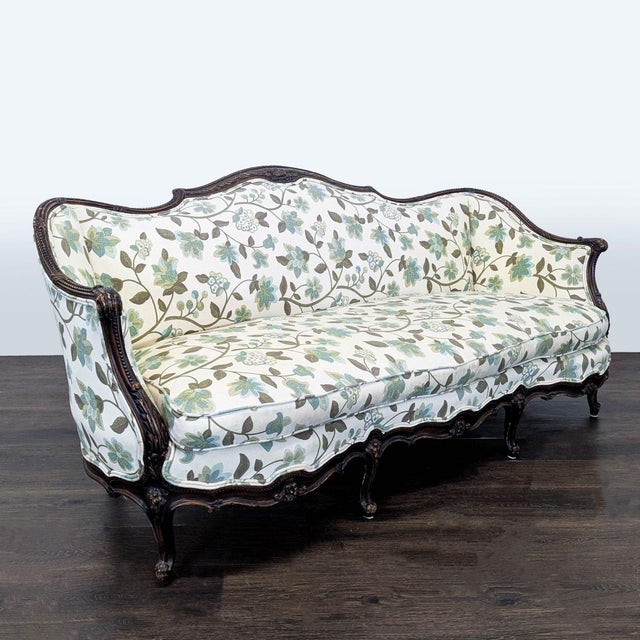 This 3-seat sofa features a sturdy carved wood frame and soft floral-patterned upholstery in calming shades of green and...