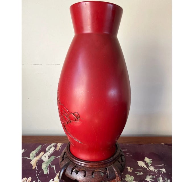 This exquisite 12-inch vase is a fine example of traditional hand-carved cinnabar lacquer. The vase features a deep,...