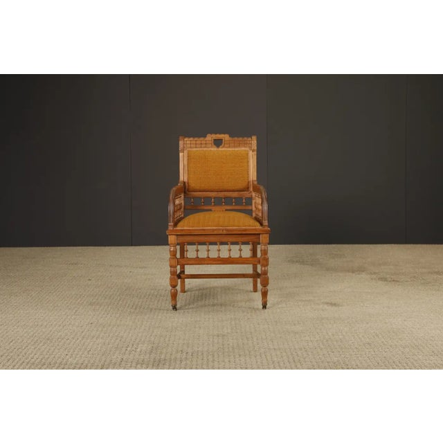 A handsome late 19th century oak armchair in the Eastlake style, reflecting the broader Aesthetic Movement and early Arts...