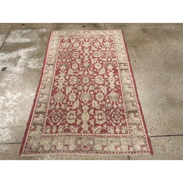 This Early 20th century Turkish Ghiordes rug, measuring 3' 6" x 5' 9", reflects the region’s long-standing tradition of...