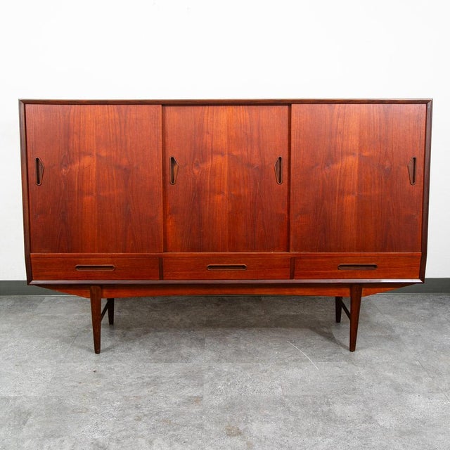Unique and handsome Danish modern Credenza / Highboard in teak now. This piece came with our latest shipment straight out...