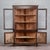 This solid wood corner display cabinet is a refined example of period furniture dating back to the 19th century. The piece...