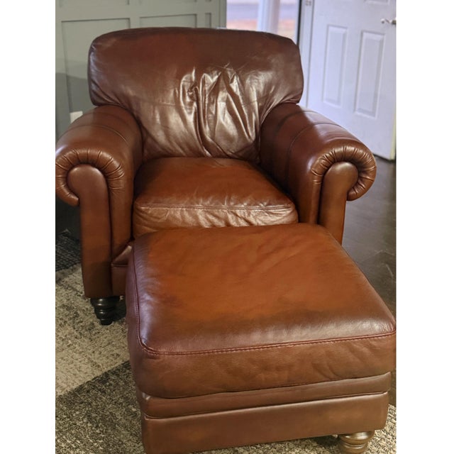 Italian-crafted Natuzzi Maturità armchair and matching ottoman upholstered in rich cognac protected top grain leather....