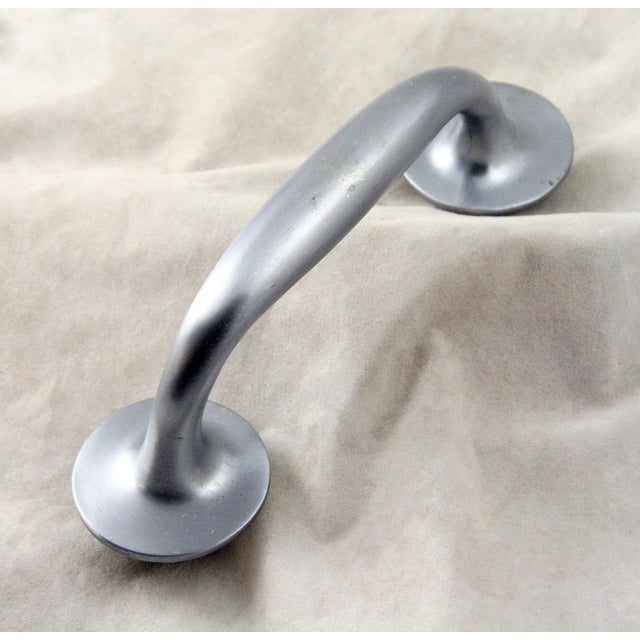 Modern style brushed nickel plated brass door pull with a satin finish. The original mounting screws are not available....