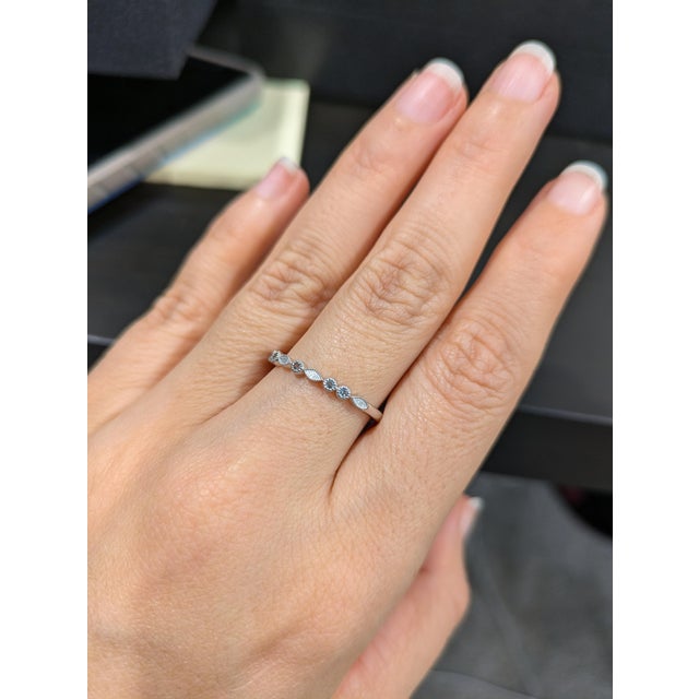 A dainty alexandrite band in solid 14k real white gold, finished with fine milgrain edging. Stackable and elegant, with...