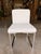 Contemporary dining chair featuring a sleek, minimalist silhouette with clean lines and tailored upholstery. Wrapped in a...