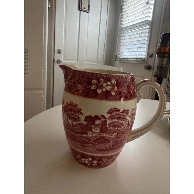 Antique Copeland Spode ironstone pitcher featuring a classic red transferware pastoral landscape with floral border. Made...