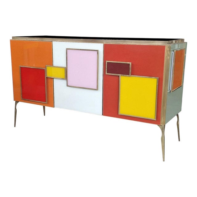 Three-door sideboard, entirely handmade, with wooden structure and colored glass surface finishes; profiles, handles and...