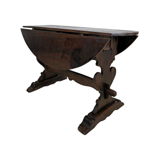 Rustic Renaissance dining table, Italy, circa 1700. Walnut. Drop-leaf form (Klapptisch). Oval top of joined boards with...