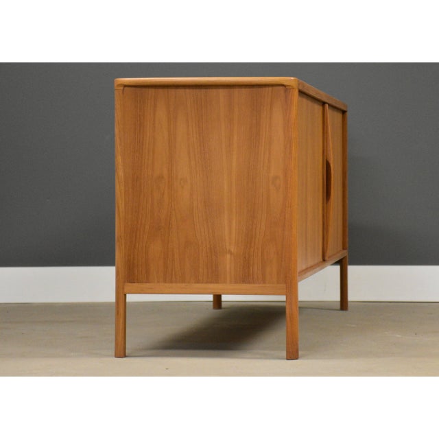 A mid century modern teak credenza with two sliding tambour doors. Made in Denmark. Circa 1960’s. Excellent condition. 66”...