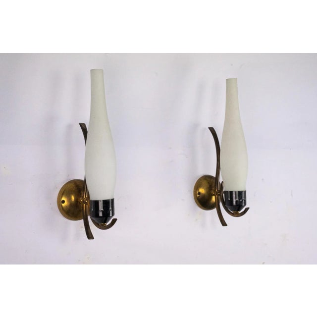 Elegant pair of Italian Mid-Century sconces, attributed to the style of Arredoluce, circa 1950s. Each sconce features a...