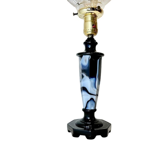 A swirling mix of black and white slag glass forms the stepped octagonal base of this 1940s table lamp by Globe Specialty...