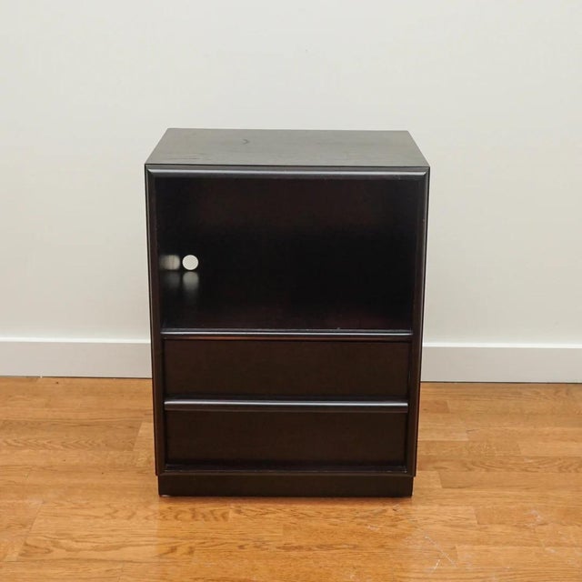 The pair of vintage nightstands, shown here, are from John Widdicomb. Finished in an ebony finish, each nightstand...