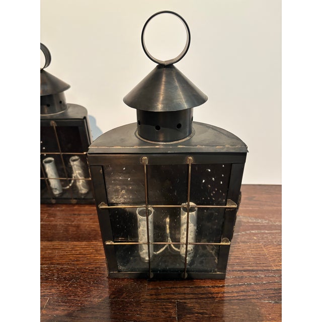 Pair of wired pierced-tin sconces with glass doors from of Genie House West.