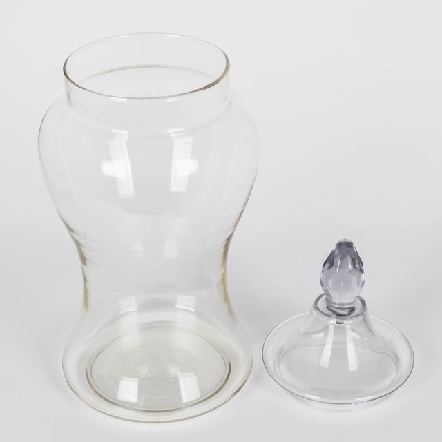 A French glass lidded apothecary or candy jar. Urn shaped faceted form. Lid with faceted cut glass knob. In good condition...