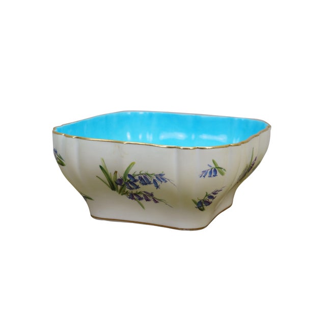 Antique Mintons porcelain serving bowl featuring a distinctive, vibrant turquoise bleu céleste glazed interior contrasted...