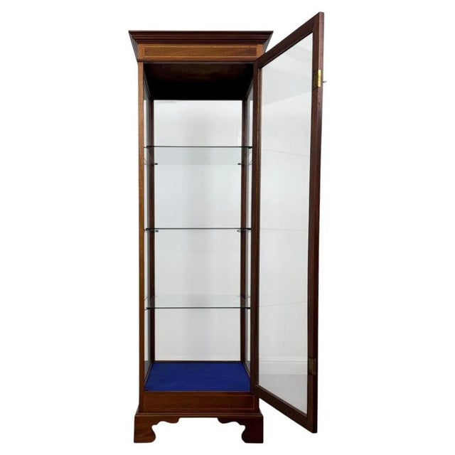 An exceptional 20th-century freestanding shop display cabinet, beautifully crafted in figured mahogany and distinguished...