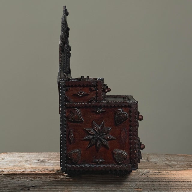 Antique Chip Carved Tramp Art Tabletop Dresser with Decoupage and Mirror At the top of the piece, a miniature Latinate-...