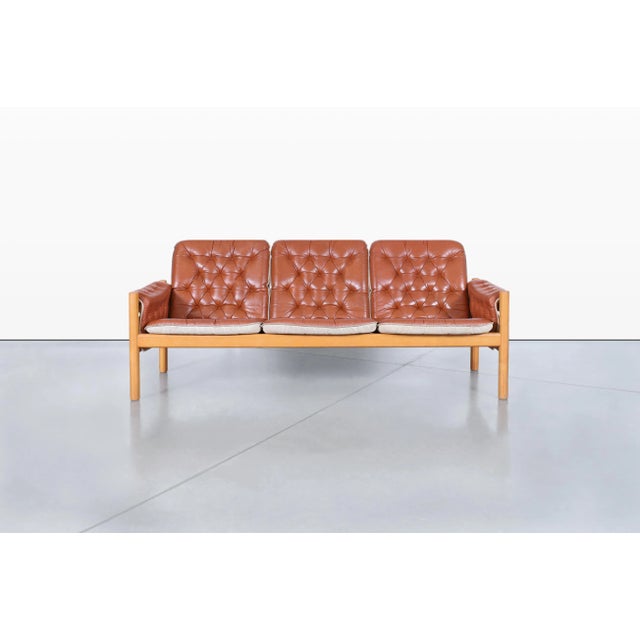Designed by Kjell Nordin for IKEA's acclaimed IREVIK collection, this mid-century modern leather sofa embodies the clean...