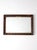 This vintage Hollywood Regency wall mirror features an ornate molded frame with scrolling foliate detail and a deep...