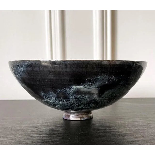 A ceramic bowl by American artist and studio potter Beatrice Wood (1893-1998). The elegant bowl has a deep half-hemisphere...
