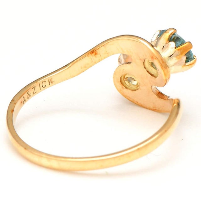 Subtle, pale shades of blue mark this bypass ring as something to admire. It has zircon and topaz that have elegantly been...