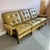 A wonderful mid century modern olive colored vinyl three seater sofa with walnut frame and buckle arm detailing. This...