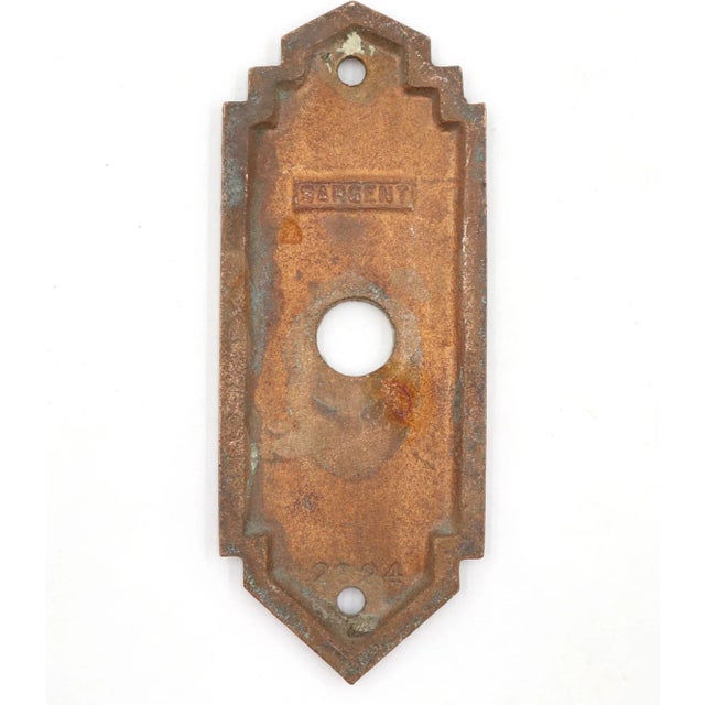 Vintage Art Deco style cast brass door bell plate with a patina. Made by Sargent. The original mounting screws are not...