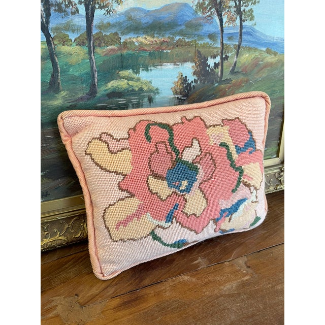 Charming handmade needlepoint pillow featuring a bold abstract floral motif in shades of pink, cream, blue, and green. The...