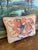 Charming handmade needlepoint pillow featuring a bold abstract floral motif in shades of pink, cream, blue, and green. The...