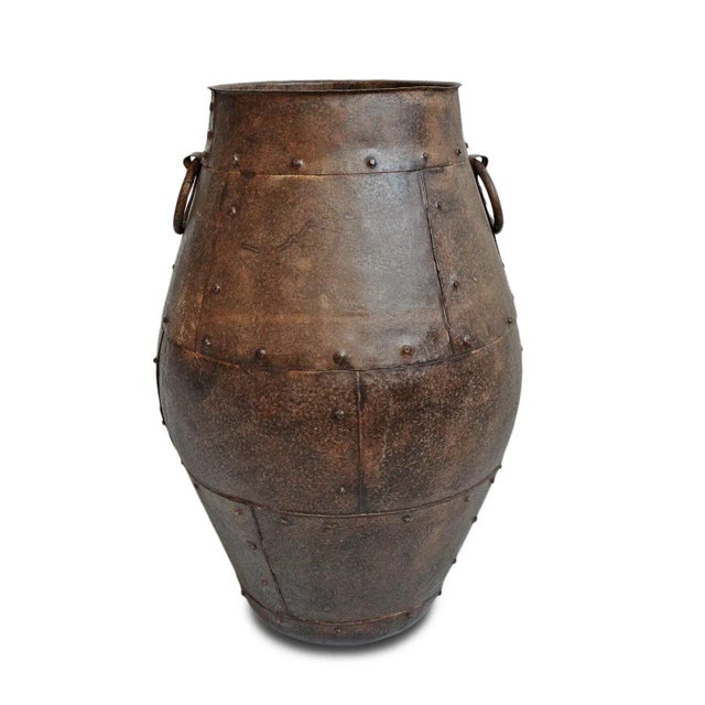 Vintage solid iron pot from India. Traditional patch work form with rivet details and iron ring handles. Originally used...