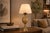 Decorative pineapple table lamp dating to circa the 1950s, made from gold-toned metal. The fruit-shaped body has a raised...