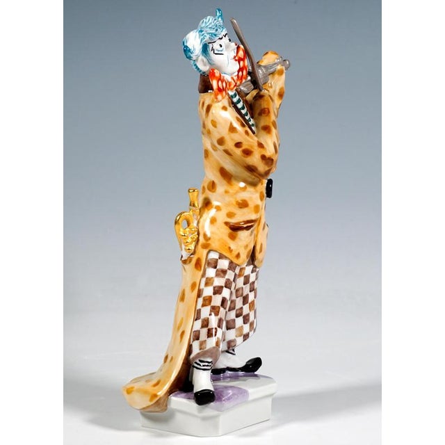 Excellent meissen porcelain figurine: clown standing with his legs apart, his face painted white and his blue hair styled...