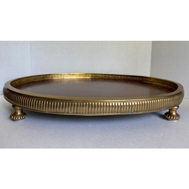 Here is a stunning tray featuring a brass base with rich, brown wood surface. The tray is in a...