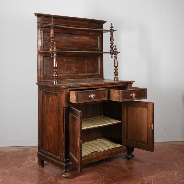 This sideboard with plate rack is a magnificent example of antique furniture, combining the sturdiness of wood with a...