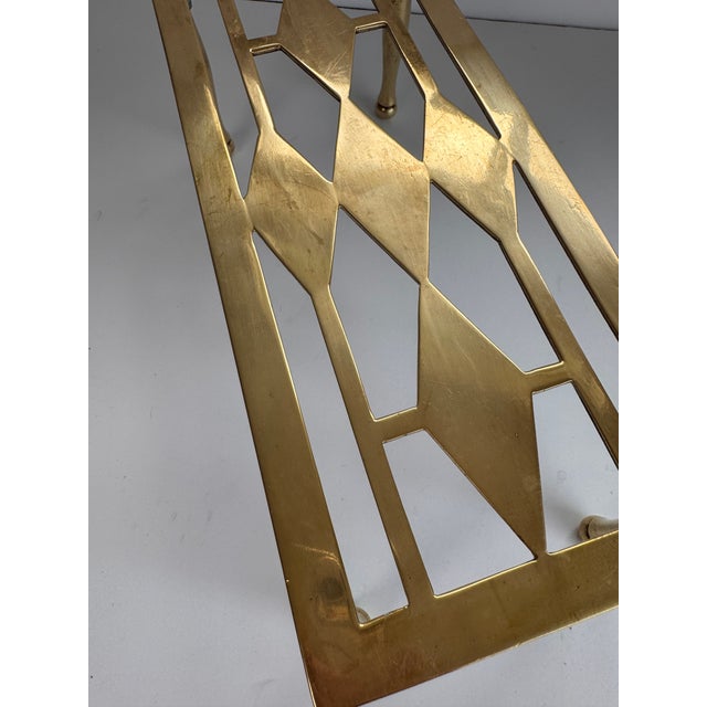 A handsome rectangular trivet from England. It has a diamond pattern reminiscent of argyle or a harlequins costume on the...